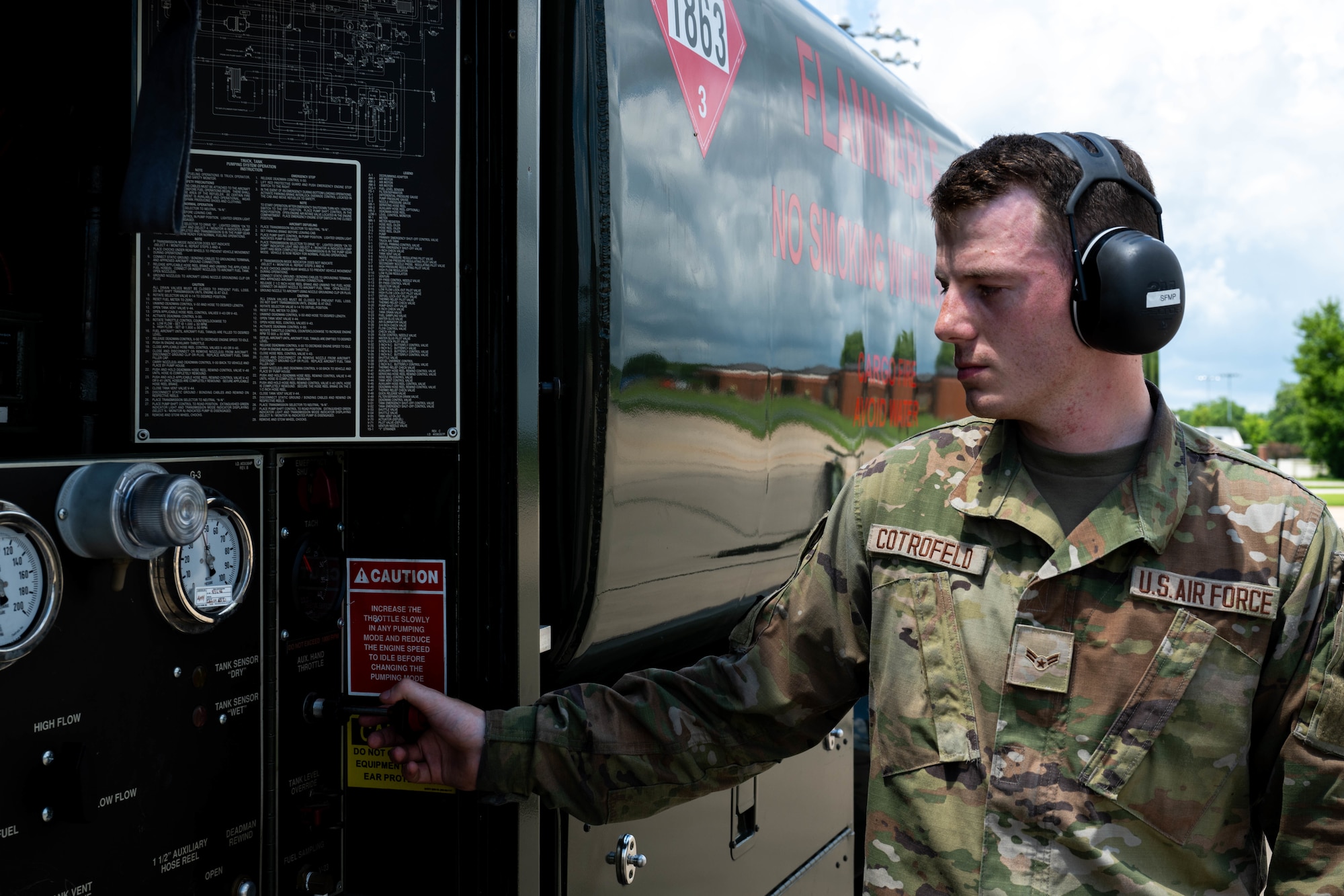 A man checks gauges on a fuels truck
