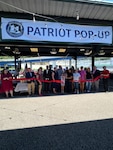 group of people cutting red ribbon