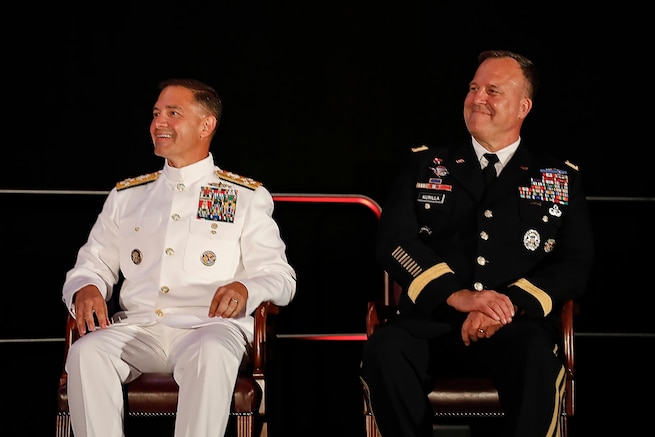 U.S. Central Command's (USCENTCOM) incoming commander, U.S. Navy Adm. Brad Cooper, left, and outgoing USCENTCOM outgoing commander, U.S. Army Gen. Michael Erik Kurilla, right, seated during a change of command ceremony, 8 August 2025. Multiple Department of Defense officials attended the event as well as distinguished defense leaders from partner nations around the world. (U.S. Central Command Public Affairs photo by Tom Gagnier)