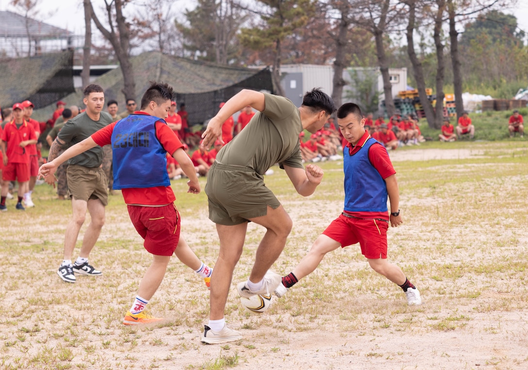 U.S. Marines with 2nd Battalion 2nd Battalion, 23rd Marines, forward deployed with 4th Marine Regiment, 3d Marine Division as part of the Unit Deployment Program, and Republic of Korea Marines with the 1st Marine Division, ROK Marine Corps, play a game of soccer during an end of exercise celebration competition as part of the Korean Marine Exercise Program 25.2 in Pohang, South Korea, Aug. 9, 2025. KMEP is conducted regularly between the ROK and U.S. Marine Corps to increase their combined capabilities through realistic training geared towards deterrence and maintaining peace in the Indo-Pacific.  (U.S. Marine Corps photo by Cpl. Kanoa Thomas)