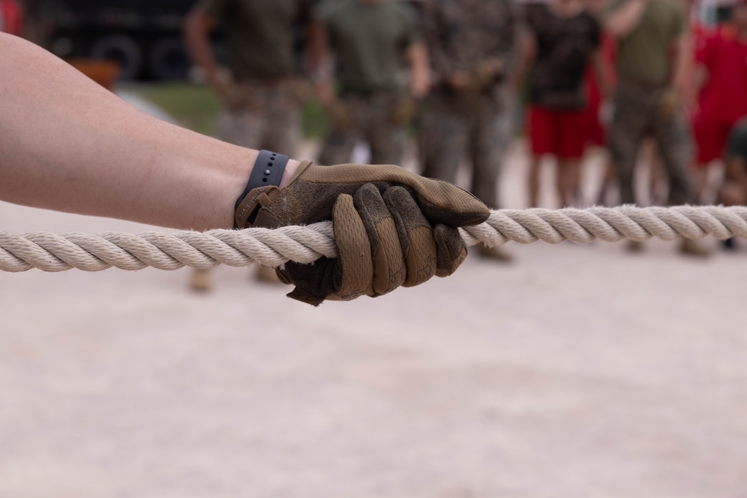 A U.S. Marine with 2nd Battalion, 23rd Marines, forward deployed with 4th Marine Regiment, 3d Marine Division as part of the Unit Deployment Program, grabs the rope before a tug of war match as part of an end of exercise celebration competition during the Korean Marine Exercise Program 25.2 in Pohang, South Korea, Aug. 9, 2025. KMEP is conducted regularly between the ROK and U.S. Marine Corps to increase their combined capabilities through realistic training geared towards deterrence and maintaining peace in the Indo-Pacific.  (U.S. Marine Corps photo by Cpl. Kanoa Thomas)
