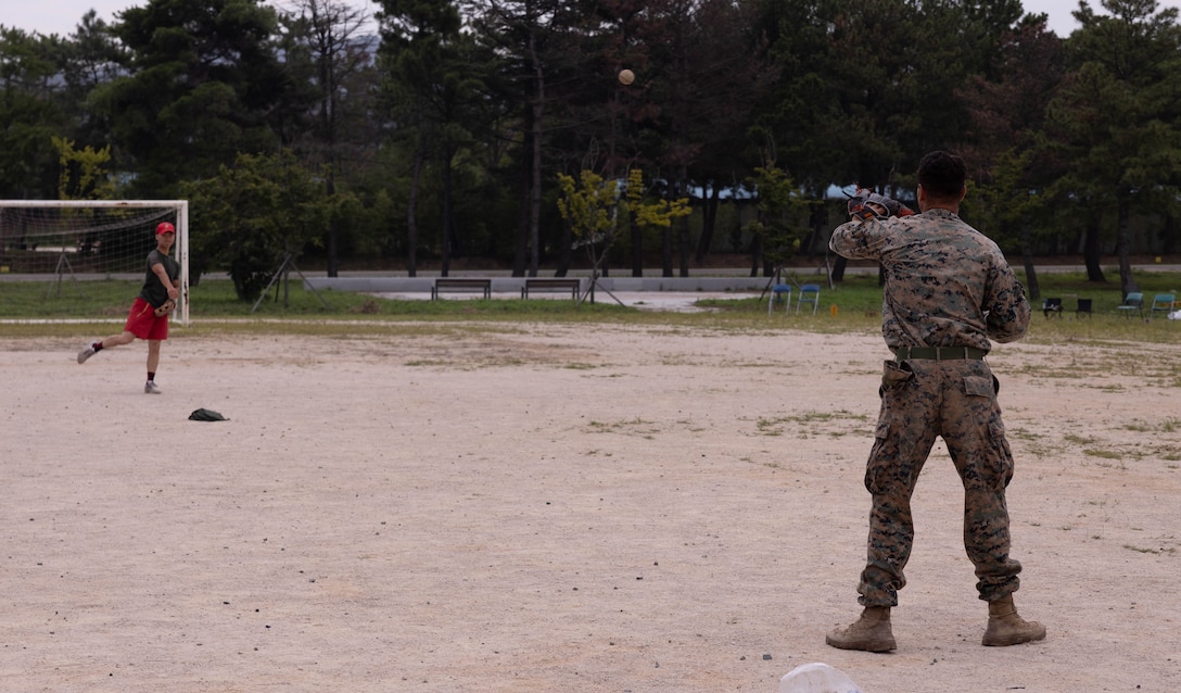U.S. Marine Corps Cpl. Jacob Huish, a rifleman with 2nd Battalion, 23rd Marines, forward deployed with 4th Marine Regiment, 3d Marine Division as part of the Unit Deployment Program, and a Republic of Korea Marine with the 1st Marine Division, ROK Marine Corps, throw a baseball together at an end of exercise celebration competition during the Korean Marine Exercise Program 25.2 in Pohang, South Korea, Aug. 9, 2025. KMEP is conducted regularly between the ROK and U.S. Marine Corps to increase their combined capabilities through realistic training geared towards deterrence and maintaining peace in the Indo-Pacific. Huish is a native of California. (U.S. Marine Corps photo by Cpl. Kanoa Thomas)