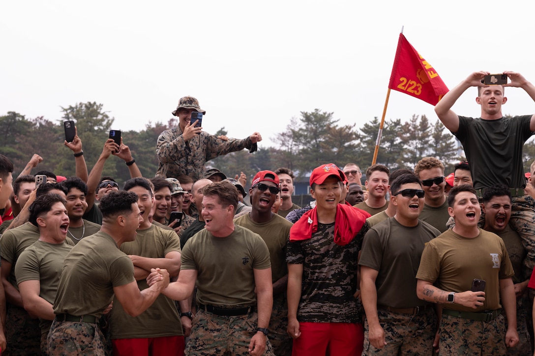U.S. Marines with 2nd Battalion 2nd Battalion, 23rd Marines, forward deployed with 4th Marine Regiment, 3d Marine Division as part of the Unit Deployment Program, and Republic of Korea Marines with the 1st Marine Division, ROK Marine Corps, cheer on their teams during an end of exercise celebration competition as part of the Korean Marine Exercise Program 25.2 in Pohang, South Korea, Aug. 9, 2025. KMEP is conducted regularly between the ROK and U.S. Marine Corps to increase their combined capabilities through realistic training geared towards deterrence and maintaining peace in the Indo-Pacific.  (U.S. Marine Corps photo by Cpl. Kanoa Thomas)