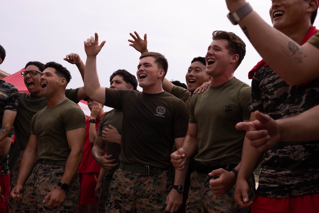 U.S. Marines with 2nd Battalion 2nd Battalion, 23rd Marines, forward deployed with 4th Marine Regiment, 3d Marine Division as part of the Unit Deployment Program, and Republic of Korea Marines with the 1st Marine Division, ROK Marine Corps, cheer on their teams during an end of exercise celebration competition as part of the Korean Marine Exercise Program 25.2 in Pohang, South Korea, Aug. 9, 2025. KMEP is conducted regularly between the ROK and U.S. Marine Corps to increase their combined capabilities through realistic training geared towards deterrence and maintaining peace in the Indo-Pacific.  (U.S. Marine Corps photo by Cpl. Kanoa Thomas)