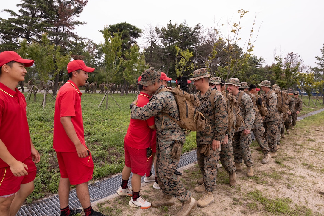 U.S. Marines with 2nd Battalion 2nd Battalion, 23rd Marines, forward deployed with 4th Marine Regiment, 3d Marine Division as part of the Unit Deployment Program, shake hands with their Republic of Korea Marines counterparts with the 1st Marine Division, ROK Marine Corps, following an end of exercise celebration competition as part of the Korean Marine Exercise Program 25.2 in Pohang, South Korea, Aug. 9, 2025. KMEP is conducted regularly between the ROK and U.S. Marine Corps to increase their combined capabilities through realistic training geared towards deterrence and maintaining peace in the Indo-Pacific.  (U.S. Marine Corps photo by Cpl. Kanoa Thomas)