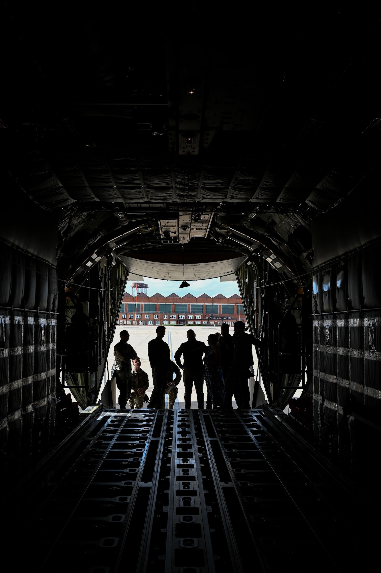 People gather on the ramp of a U.S. Air Force MC-130J Commando II from the 352nd Special Operations Wing at RAF Mildenhall, England, Aug. 14, 2025.