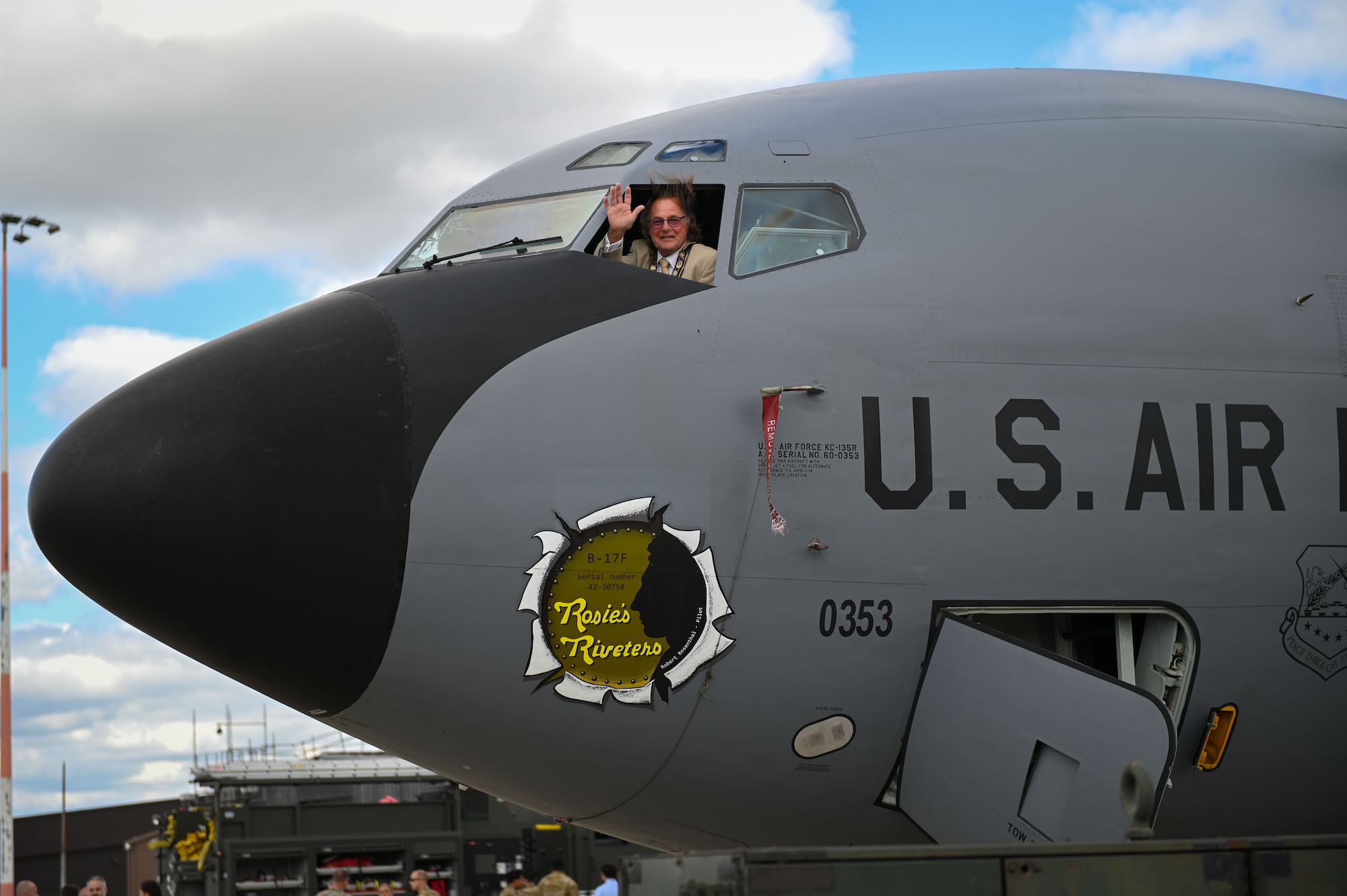 Councilor Philip Wittam, Chair of the West Suffolk Council, waves out of the window of a U.S. Air Force KC-135 Stratotanker assigned to the 100th Air Refueling Wing during the 100th ARW’s Key Leader Engagement Day on RAF Mildenhall, England, Aug. 14, 2025. Councilor Wittam was invited to participate in a tour where he was briefed on the innovation happening at RAF Mildenhall that may affect his community as well. (U.S. Air Force photo by Airman 1st Class Chloe Masey)