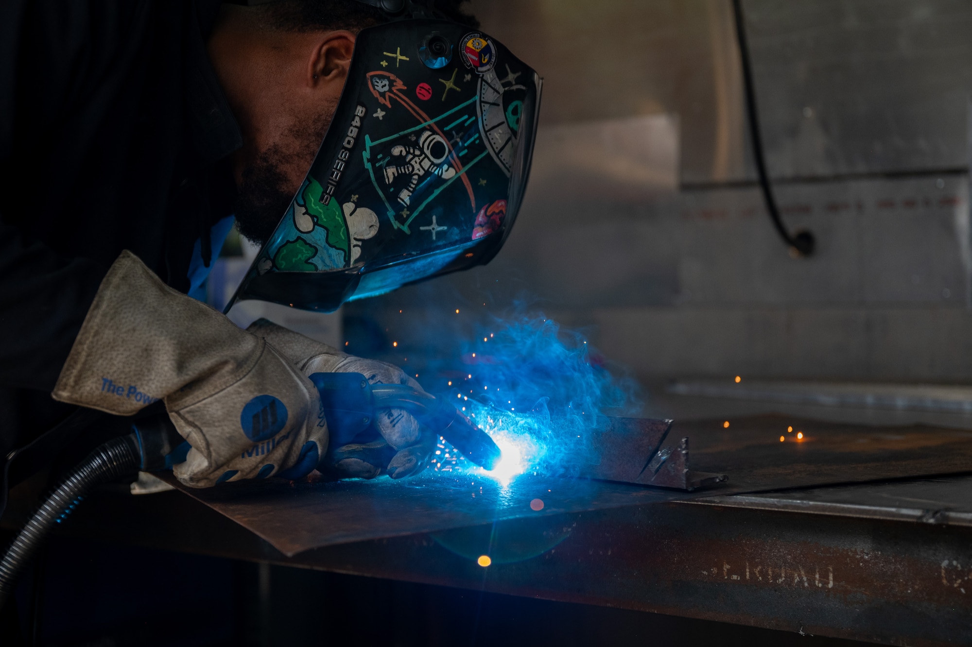 Airman welds two metal components together