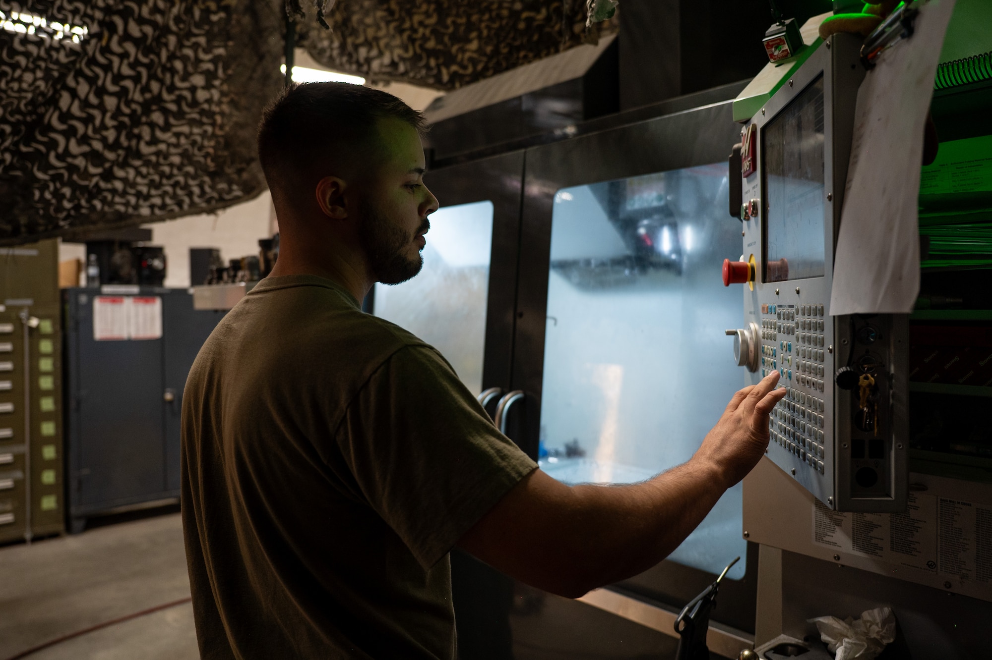 Airman operates a CNC machine