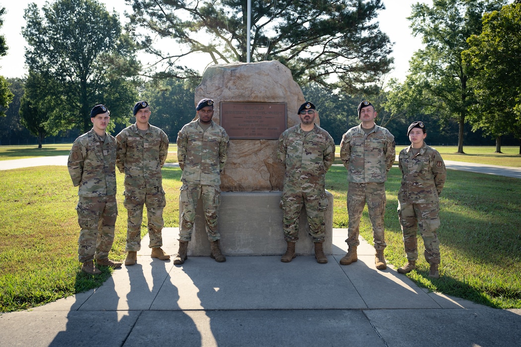 Members of the 78th Security Forces Squadron at Robins Air Force Base, Georgia, on temporary duty at Arnold Air Force Base, Tenn., gather for a photo Aug. 7, 2025, at the flagpole in front of the Arnold AFB Administration and Engineering Building. The 78 SFS Team arrived at Arnold on Aug. 2, 2025, to provide law enforcement support to Arnold AFB Department of the Air Force police officers. Pictured from left are Airman 1st Class Colby Mercer, Airman 1st Class Hunter Stone, Senior Airman Clarence Hitchcock, Tech Sgt. Joseph Jones, Senior Airman Chambliss McKendree and Airman 1st Class Hallie Ogle. (U.S. Air Force photo by Keith Thornburgh)