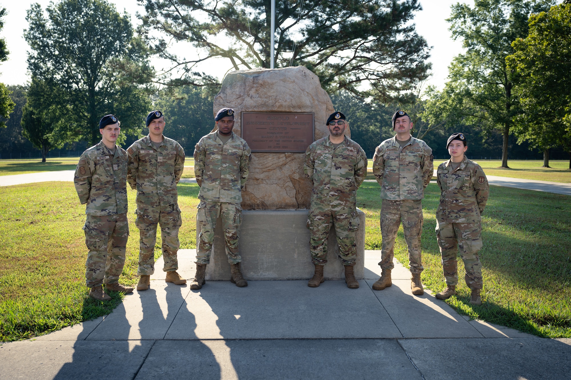 Members of the 78th Security Forces Squadron at Robins Air Force Base, Georgia, on temporary duty at Arnold Air Force Base, Tenn., gather for a photo Aug. 7, 2025, at the flagpole in front of the Arnold AFB Administration and Engineering Building. The 78 SFS Team arrived at Arnold on Aug. 2, 2025, to provide law enforcement support to Arnold AFB Department of the Air Force police officers. Pictured from left are Airman 1st Class Colby Mercer, Airman 1st Class Hunter Stone, Senior Airman Clarence Hitchcock, Tech Sgt. Joseph Jones, Senior Airman Chambliss McKendree and Airman 1st Class Hallie Ogle. (U.S. Air Force photo by Keith Thornburgh)