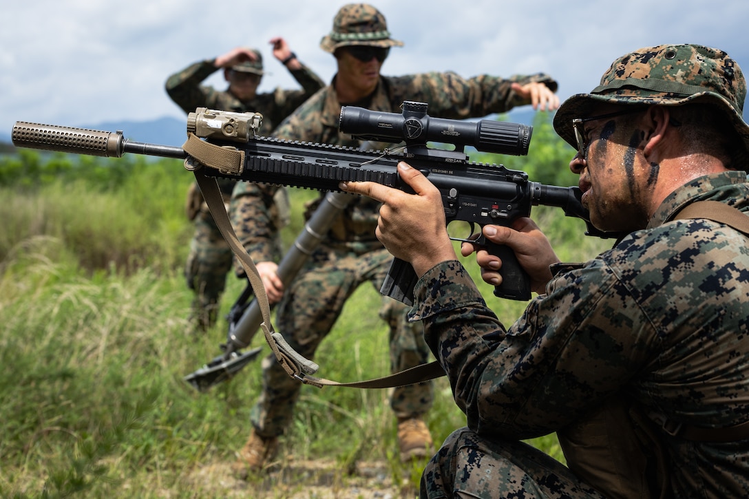 A U.S. Marine with 2nd Battalion, 23rd Marines, forward deployed with 4th Marine Regiment, 3d Marine Division as part of the Unit Deployment Program, provides suppressive fires as two mortarmen return to cover during the Korean Marine Exercise Program 25.2 in Pohang, South Korea, August 5, 2025. KMEP is conducted regularly between the ROK and U.S. Marine Corps to increase their combined capabilities through realistic training geared towards deterrence and maintaining peace in the Indo-Pacific. (U.S. Marine Corps photo by Lance Cpl. Van Hoang)