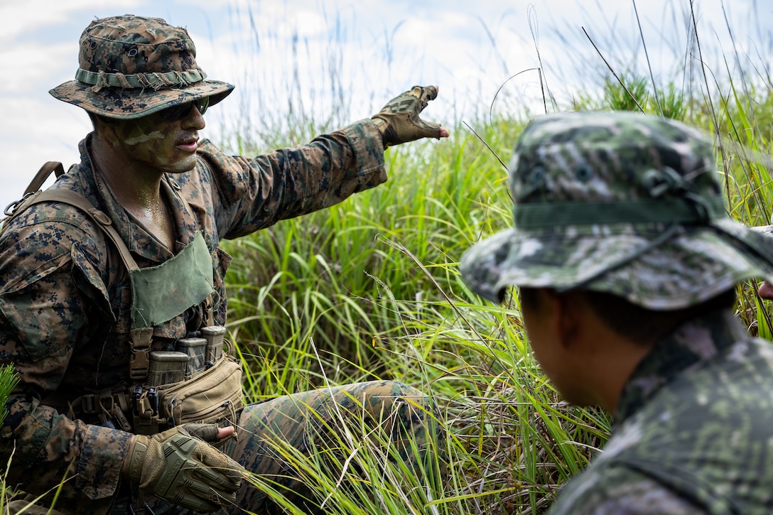 U.S. Marine Corps Sgt. Joshiwa Juni, a squad leader with 2nd Battalion, 23rd Marines, forward deployed with 4th Marine Regiment, 3d Marine Division as part of the Unit Deployment Program, links up with a Republic of Korean Marine and coordinates an assault on a simulated enemy position during the Korea Marine Exercise Program 25.2 in Pohang, South Korea, August 5, 2025. KMEP is conducted regularly between the ROK and U.S. Marine Corps to increase their combined capabilities through realistic training geared towards deterrence and maintaining peace in the Indo-Pacific. (U.S. Marine Corps photo by Lance Cpl. Van Hoang)