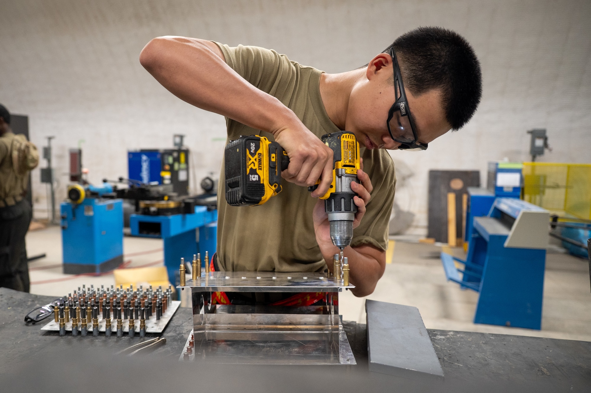 Airman drills a hole in a simulated aircraft structure
