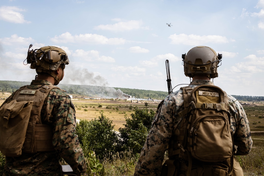 U.S. Marines with 1st Air Naval Gunfire Liaison Company, I Marine Expeditionary Force Information Group, observe close air support with Marine Light Attack Helicopter Squadron (HMLA) 775 during Northern Strike 25-2 at Camp Grayling, Michigan, Aug. 15, 2025.  Marines participating in the exercise continue to train and enhance the survivability and the lethality of the naval expeditionary force, while fully integrating with joint forces and multinational partners. (U.S. Marine Corps photo by Cpl. Peyton Kahle)