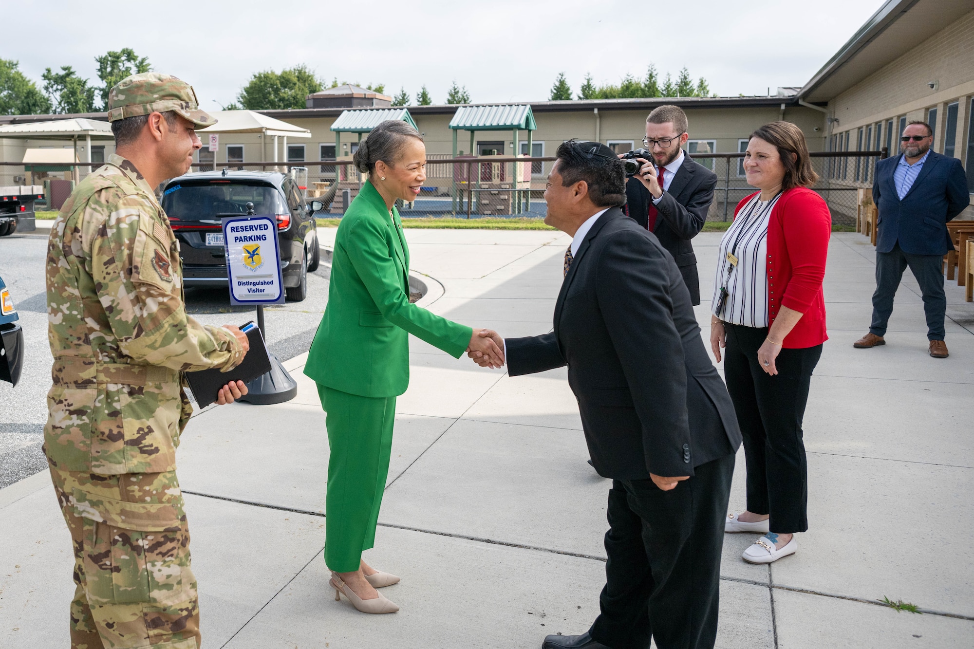 Dr. Francisco Brizuela, right, 436th Force Support Squadron child and youth services flight chief, greets Sen. Lisa Blunt Rochester, center, and Col. Jamil Musa, left, 436th Airlift Wing commander, during a tour of the Child Development Center at Dover Air Force Base, Delaware, Aug. 12, 2025.