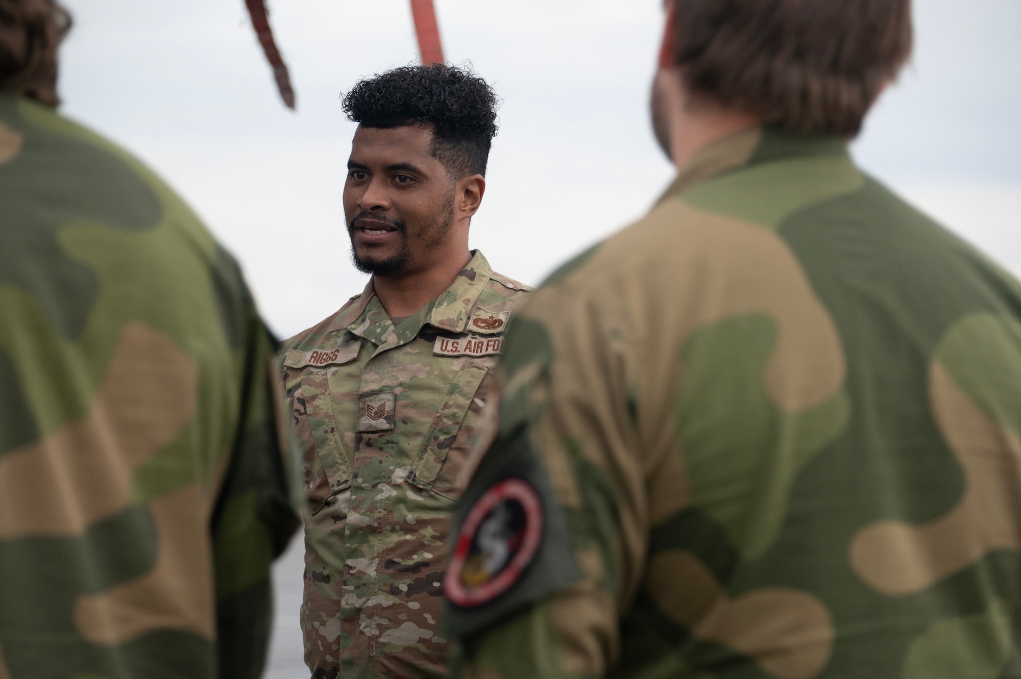 An airman walks around a plane