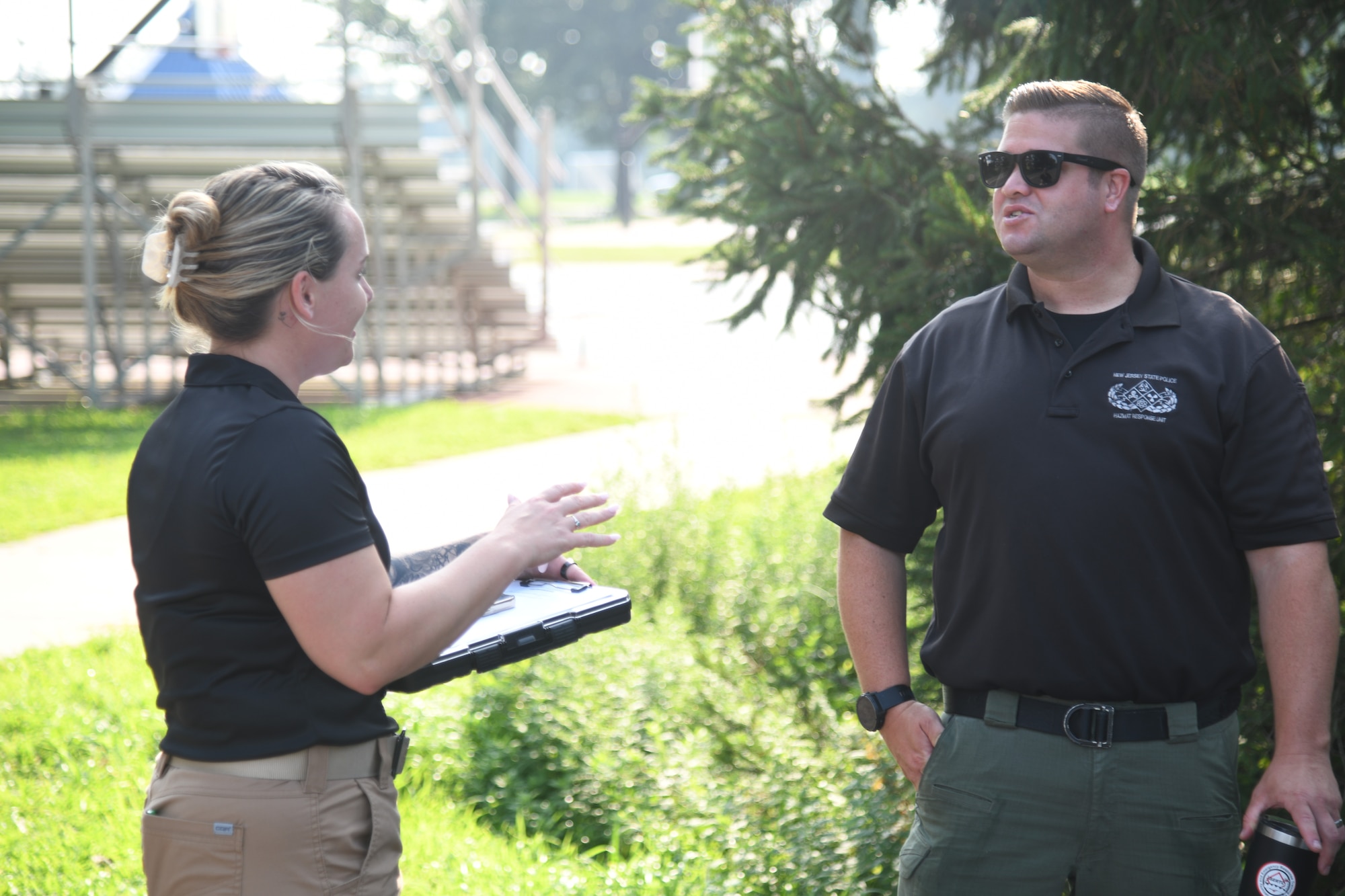 U.S. Army Capt. Jennifer Wain, left, 21st Weapons of Mass Destruction-Civil Support Team operations officer, speaks with Mr. Sean McGurr, New Jersey State Police emergency response specialist, before a training exercise at Mercer County Park, West Windsor Township, West Windsor Township, N.J., July 31, 2025.