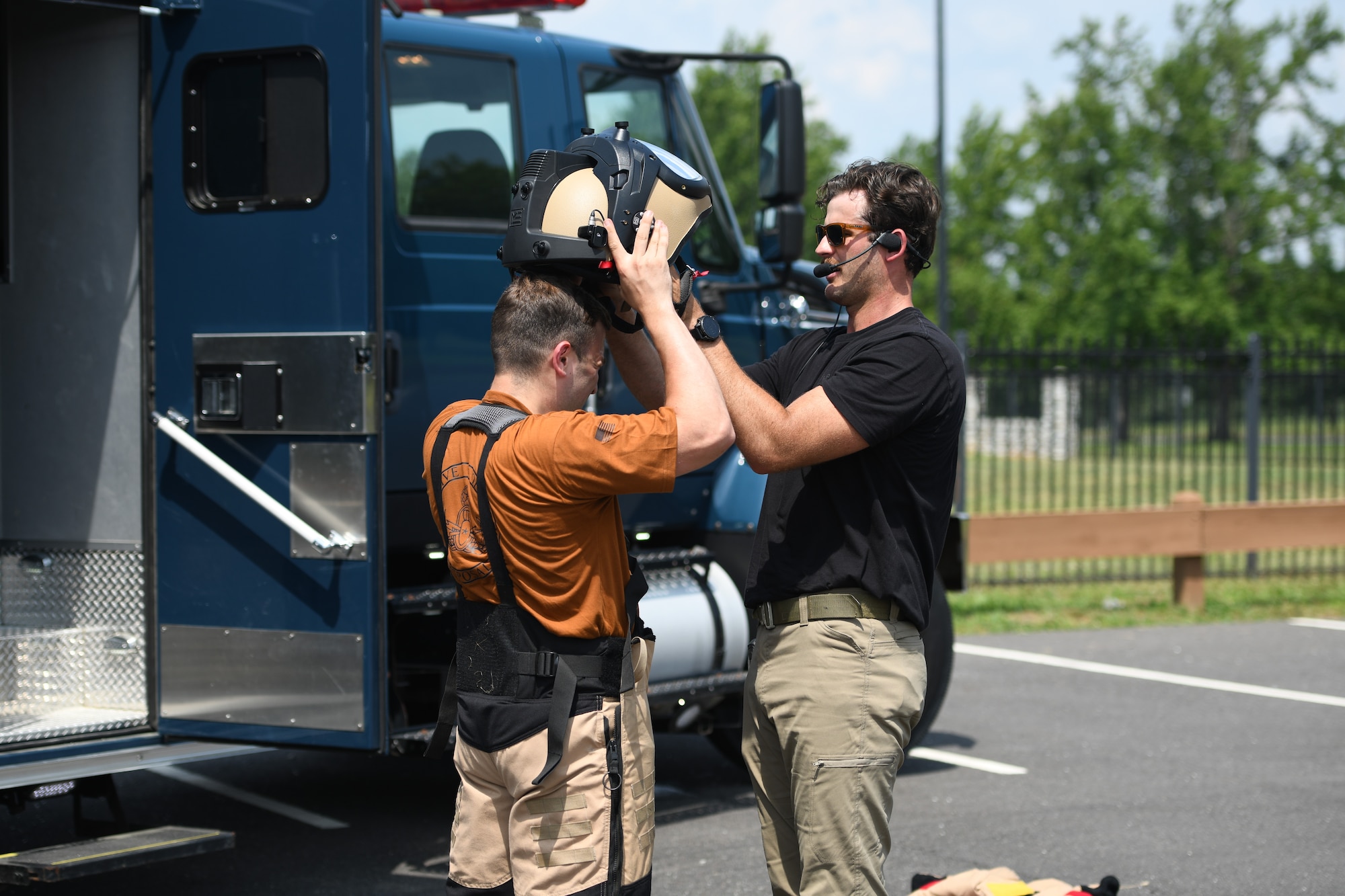 U.S. Air Force Senior Airman Robert Wittig, 177th Civil Engineer Squadron explosive ordnance disposal team technician, right, assists fellow team technician, Staff Sgt. Russell Bongiovanni, don an EOD bomb suit during a training exercise at Mercer County Park, West Windsor Township, New Jersey, July 31, 2025.