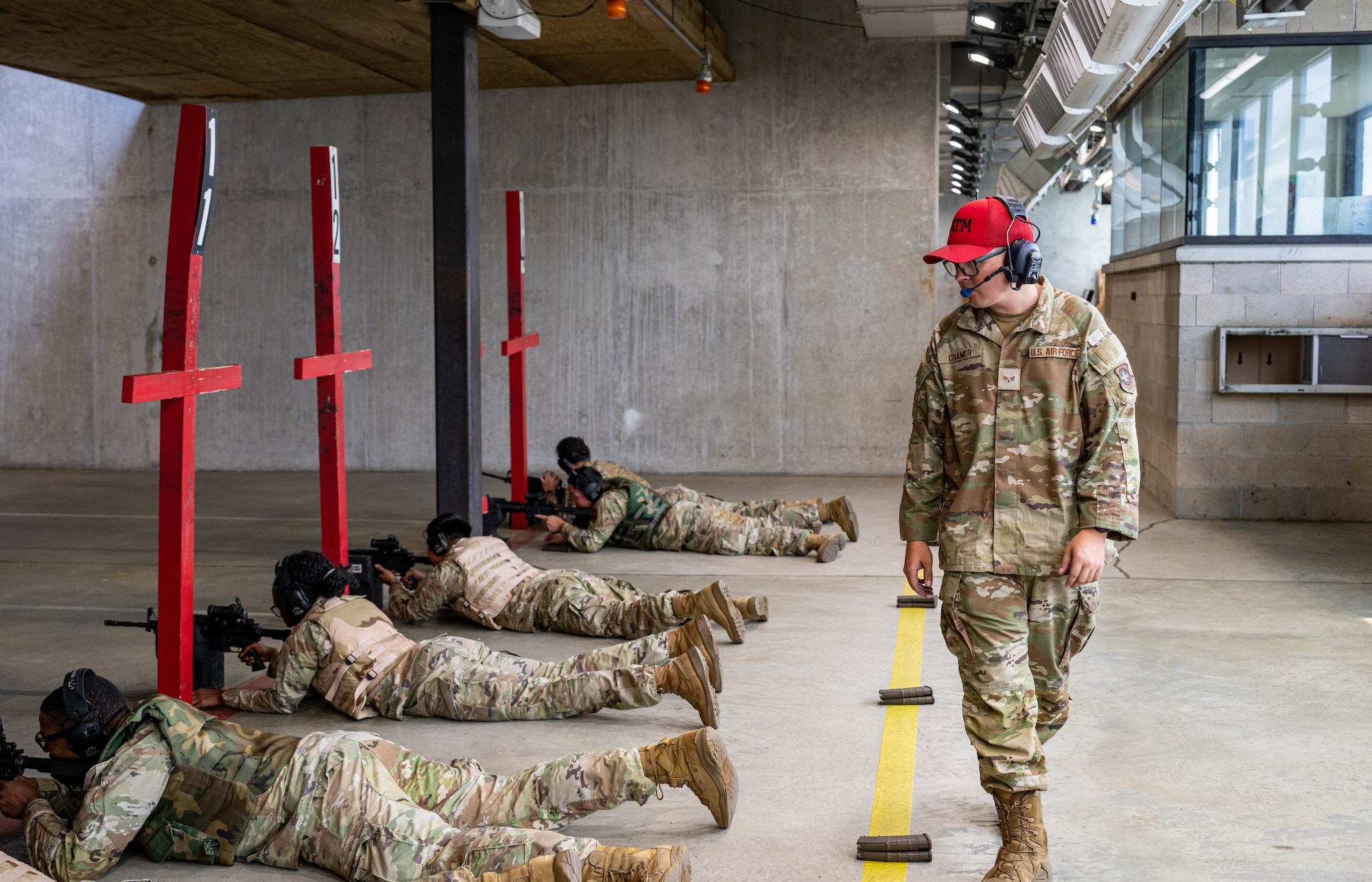 U.S. Air Force Senior Airman Troy Cramer, 436th Security Forces Squadron combat arms training and maintenance instructor, observes students on the firing line during a CATM course at Dover Air Force Base, Delaware, Aug. 7, 2025.
