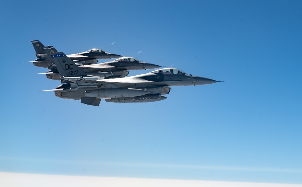 F-16 Fighting Falcons assigned to the 113th Fighter Wing, District of Columbia Air National Guard, Joint Base Andrews, Maryland; the 85th Test and Evaluation Squadron, Eglin Air Force Base, Florida; and the 96th Test Wing, Eglin AFB, Florida, fly off the wing of a KC-46A Pegasus operated by aircrew assigned to the 22nd Air Refueling Wing, McConnell Air Force Base, Kansas, during Exercise Bamboo Eagle 25-3, off the coast of California, Aug. 7, 2025. Bamboo Eagle 25-3 is a joint military training exercise involving service members from the U.S. Department of Defense operating, maintaining, commanding and controlling and supporting more than 100 aircraft at over 15 locations. (U.S. Air Force photo by Staff Sgt. Tryphena Mayhugh)