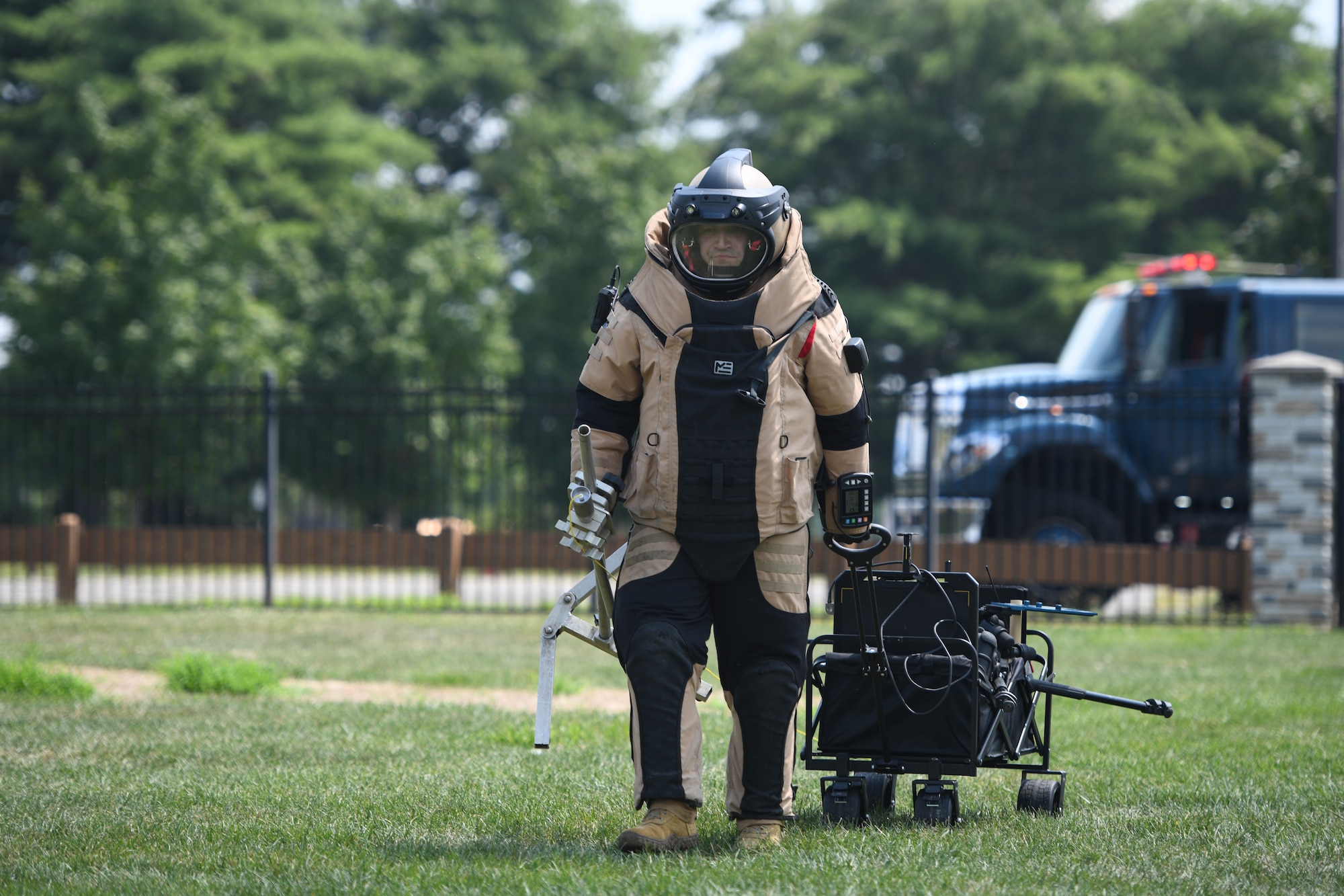 U.S. Air Force Staff Sgt. Russell Bongiovanni, 177th Civil Engineer Squadron explosive ordnance disposal team technician, walks to a simulated hazardous material area with EOD bomb gear and equipment for reconnaissance during a training exercise at Mercer County Park, West Windsor Township, New Jersey, July 31, 2025.