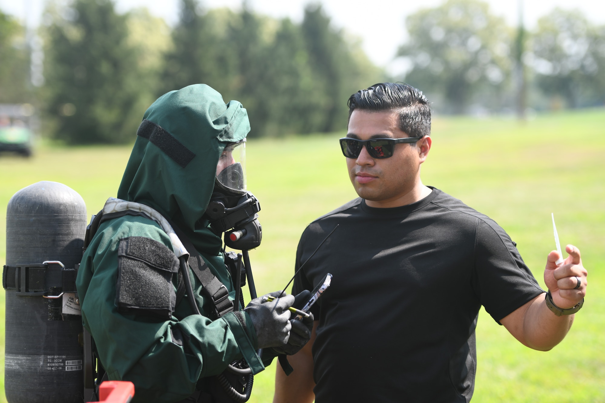 From left, U.S. Army Spc. Andrew DeJesus, member of the New Jersey National Guard’s 21st Weapons of Mass Destruction–Civil Support Team, listens to Staff Sgt. Christopher Mejia, 21st WMD-CST noncommissioned officer of training, during a joint training exercise at Mercer County Park, West Windsor Township, New Jersey, July 31, 2025.