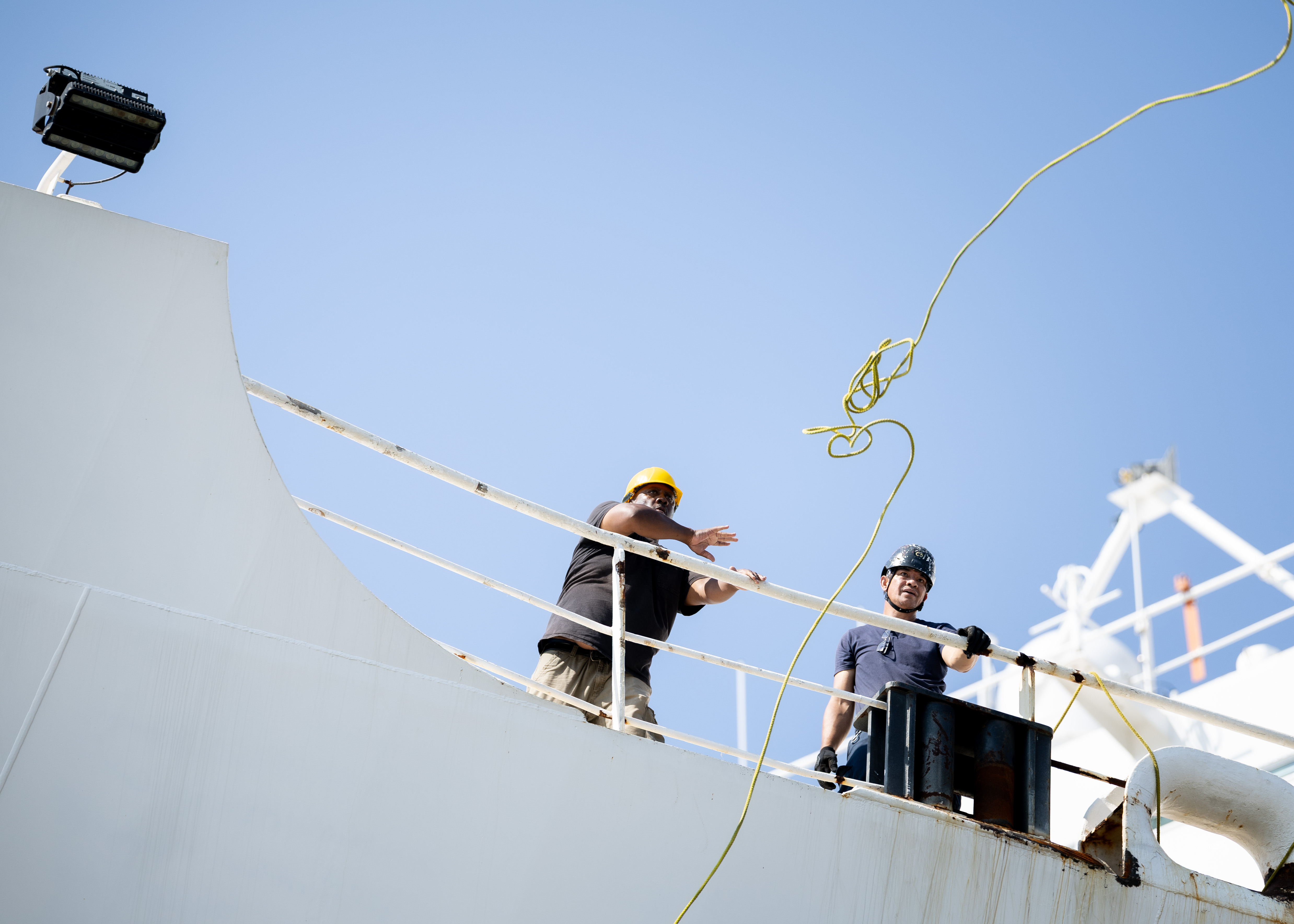 A Civil Service Mariner (CIVMAR) assigned to USNS Comfort (T-AH 20) throws a heaving line to the pier as they arrive back at Naval Station Norfolk after completing its summer deployment to the U.S. Southern Command area of operations as part of Continuing Promise 2025 Aug. 17, 2025. Comfort completed six mission visits to Grenada, Panama, Ecuador, Dominican Republic, Costa Rica, Trinidad and Tobago, providing direct care to thousands of patients.