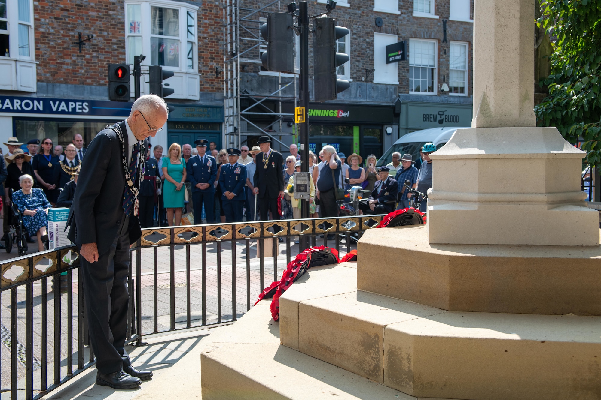A local official bows his head in remembrance during the 80th anniversary Victory over Japan Day ceremony