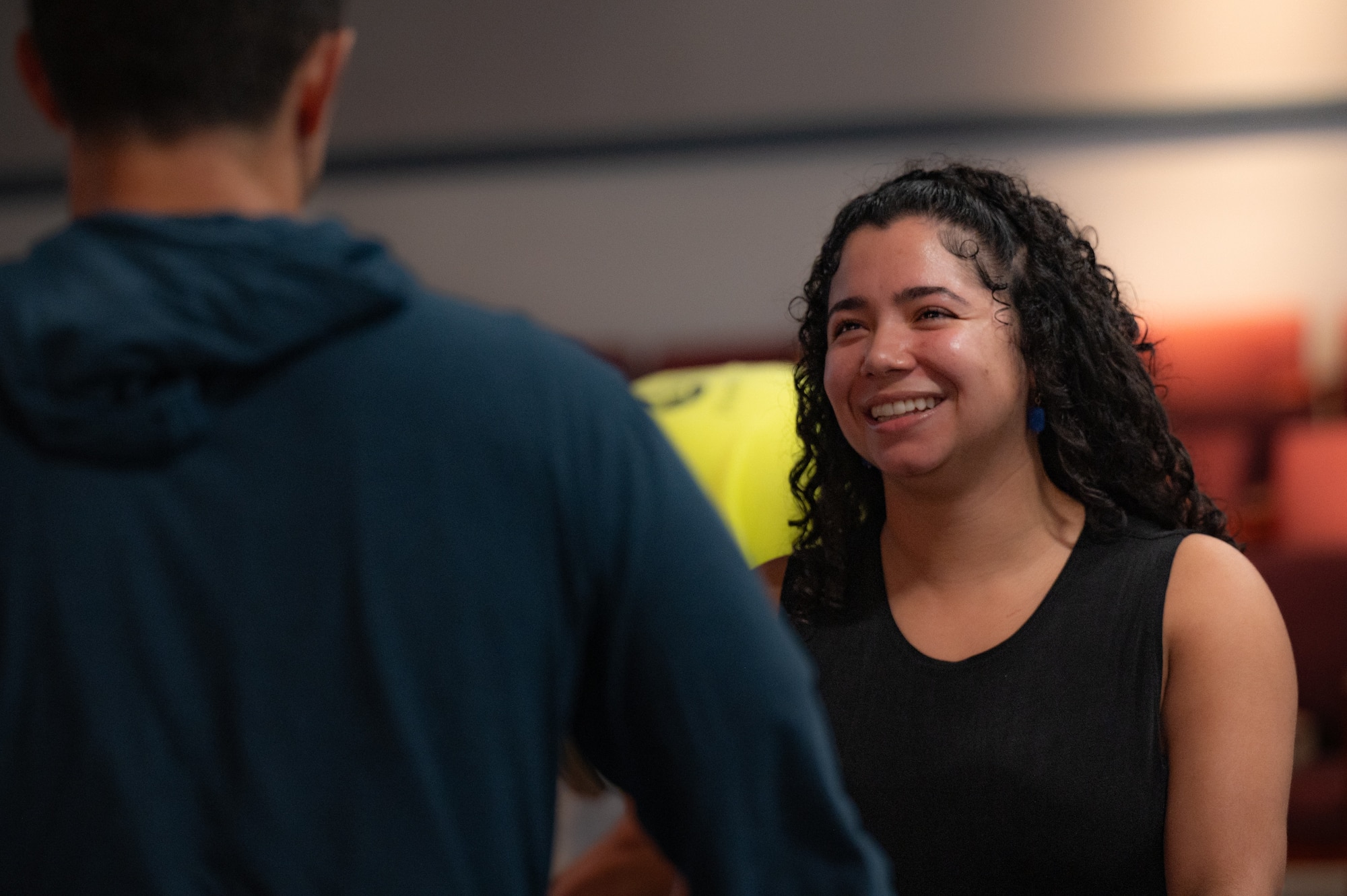 Mariah Cabrera (right side of photo) smiles and engages with U.S. Air Force Nicholas Bonavita (left side of photo)