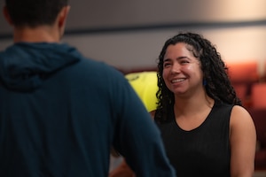 Mariah Cabrera (right side of photo) smiles and engages with U.S. Air Force Nicholas Bonavita (left side of photo)