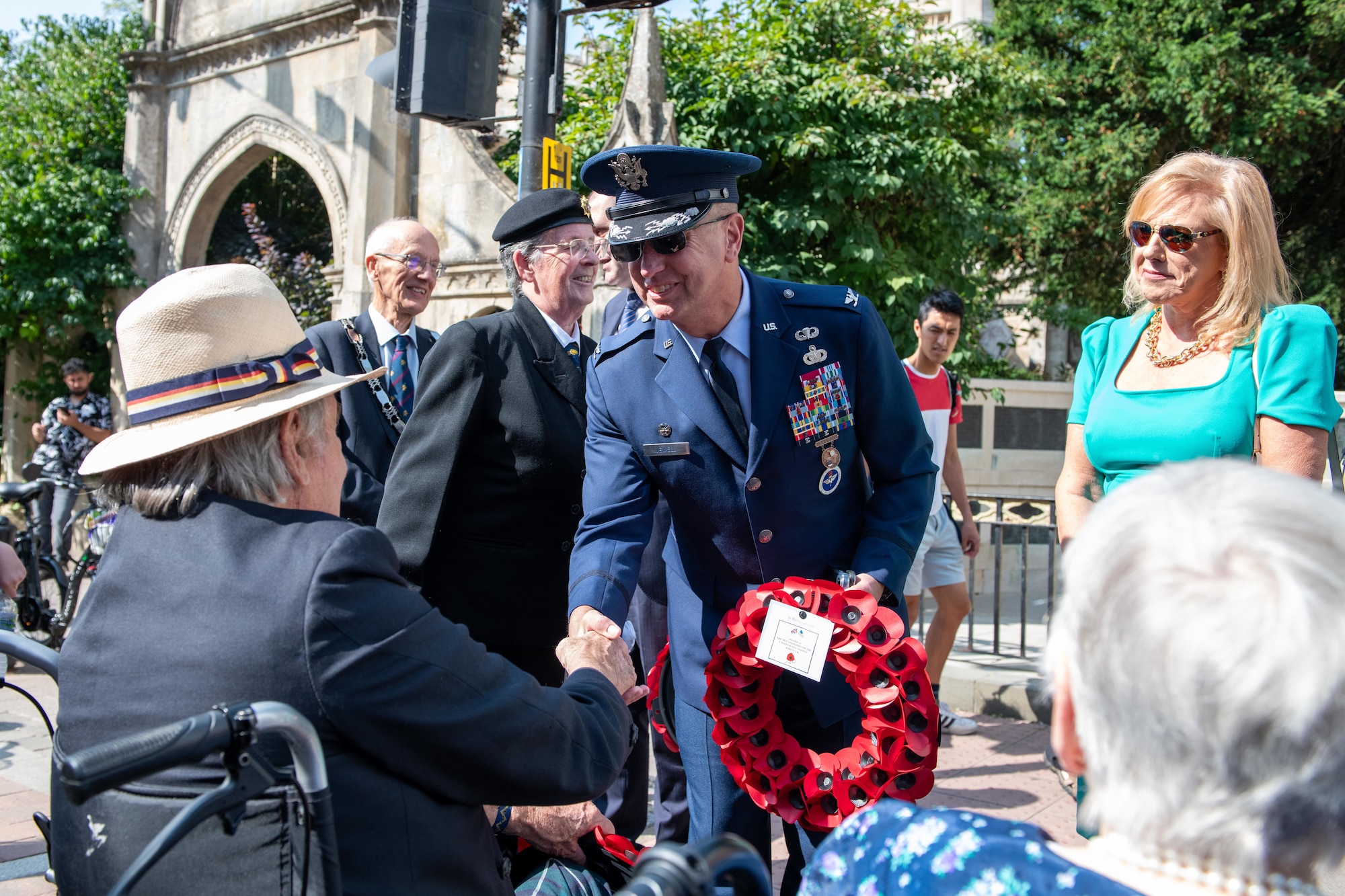 Col. Michael Jewell shakes hands with a veteran during the 80th anniversary Victory over Japan Day ceremony