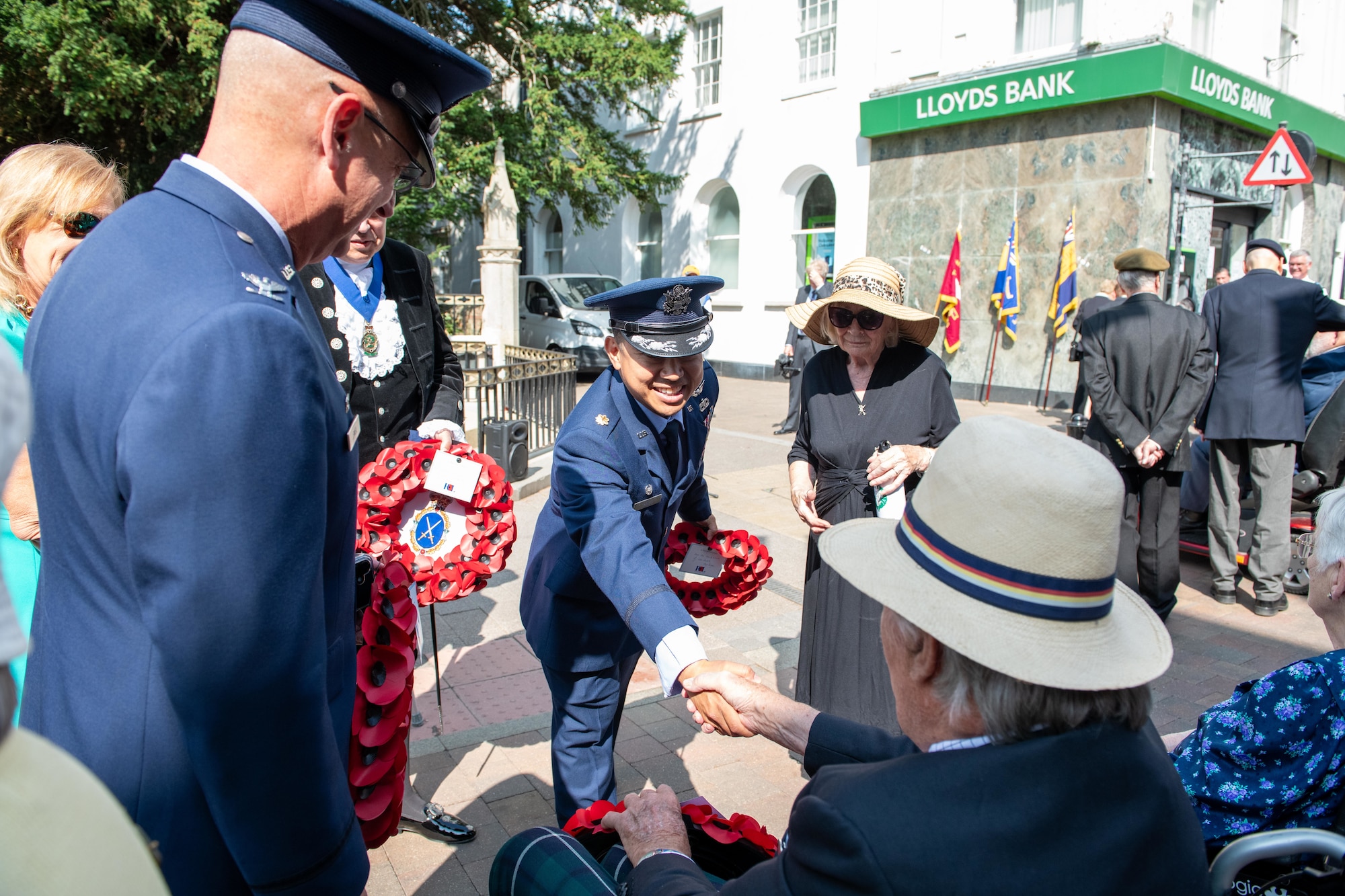 Maj. Marques Reyes greets a veteran during the 80th anniversary Victory over Japan Day ceremony
