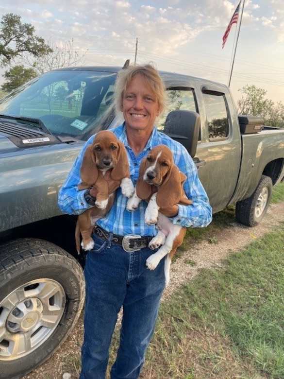 Jennifer Plair, a civil engineering technician at Fort Worth District’s Somerville Lake, holds her two dogs. In May of 2025 she was inducted into the Somerville High School Hall of Honor.