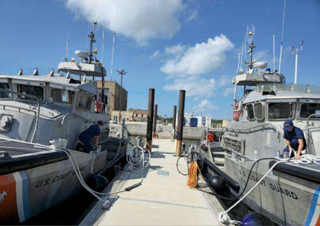 Members of U.S. Coast Guard Station Hatteras Inlet check mooring lines aboard 47ft Motor Life Boats at Cape Hatteras, NC, Aug 19, 2025. Coast Guard units and crews along the East Coast strategically moved personnel, equipment, and resources in anticipation of Hurricane Erin. (U.S. Coast Guard Courtesy Photo)