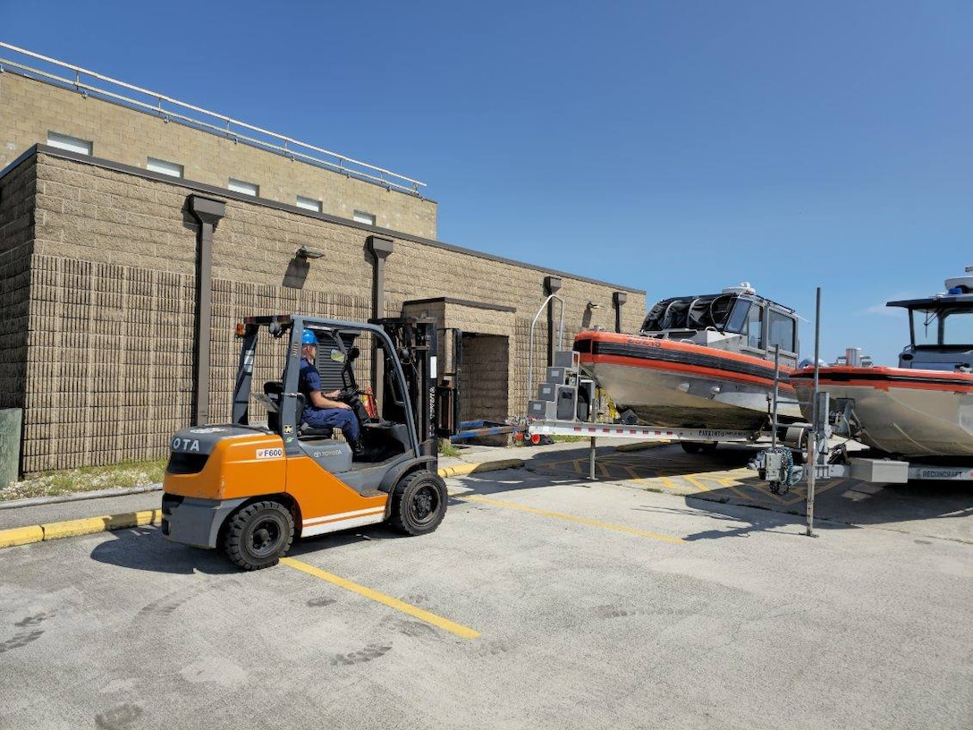 A member of U.S. Coast Guard Station Hatteras Inlet uses a forklift to move a 29ft Response Boat Small II at Cape Hatteras, NC, Aug 19, 2025. Coast Guard units and crews along the East Coast strategically moved personnel, equipment, and resources in anticipation of Hurricane Erin. 

(U.S. Coast Guard Courtesy Photo)