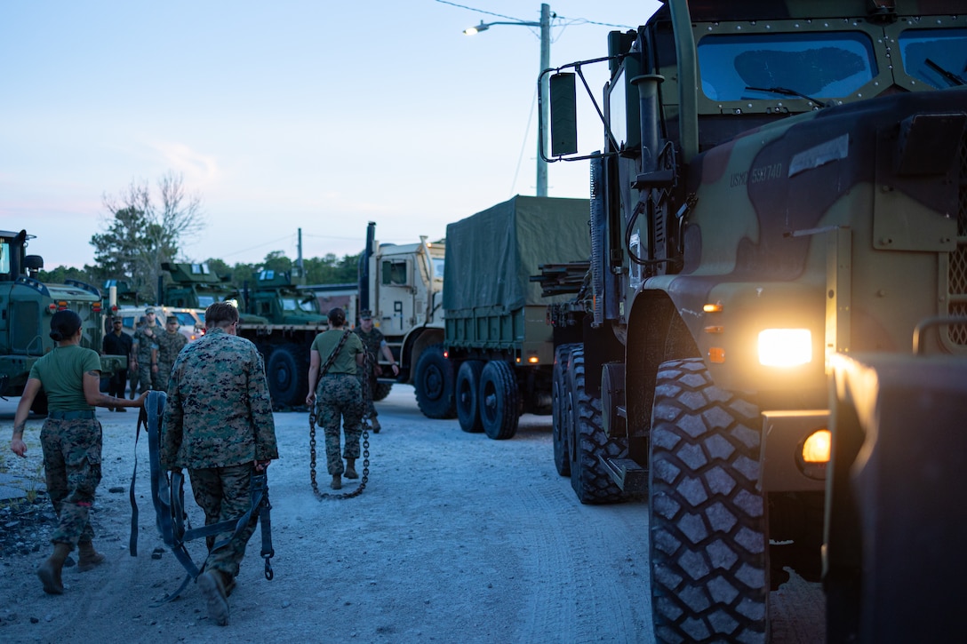 U.S. Marines with Combat Logistics Battalion 22, Combat Logistics Regiment 27, prepare tactical vehicles for a convoy to Marine Corps Base Quantico from Marine Corps Base Camp Lejeune, North Carolina, July 20, 2025. The logistics combat element of the Special Purpose Marine Air-Ground Task Force – Alert Contingency MAGTF (SPMAGTF-ACM), CLB-22, conducted a deployment for training to increase proficiency in comprehensive combat service support and improve overall combat readiness for any potential MAGTF missions. (U.S. Marine Corps photo by Lance Cpl. Jack Labrador)