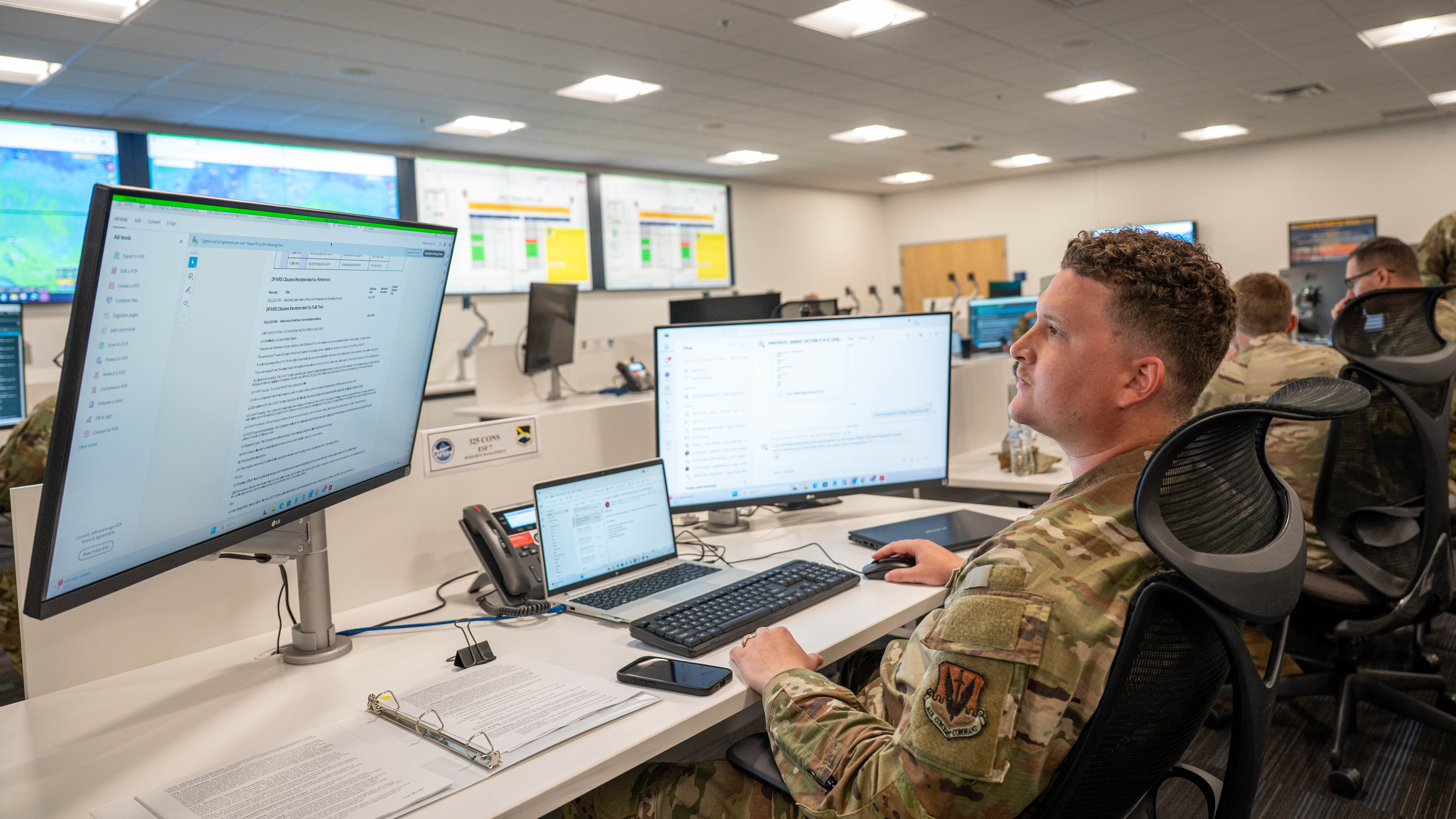 A contracting officer completes checklists at his worktop.