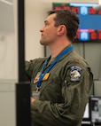 uniformed U.S. Airman writes on whiteboard