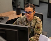 uniformed U.S. Airman works at a computer