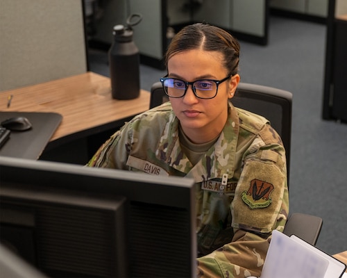 uniformed U.S. Airman works at a computer