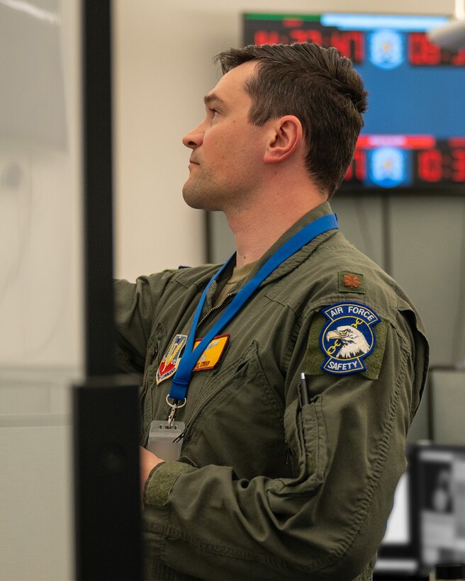 uniformed U.S. Airman writes on whiteboard