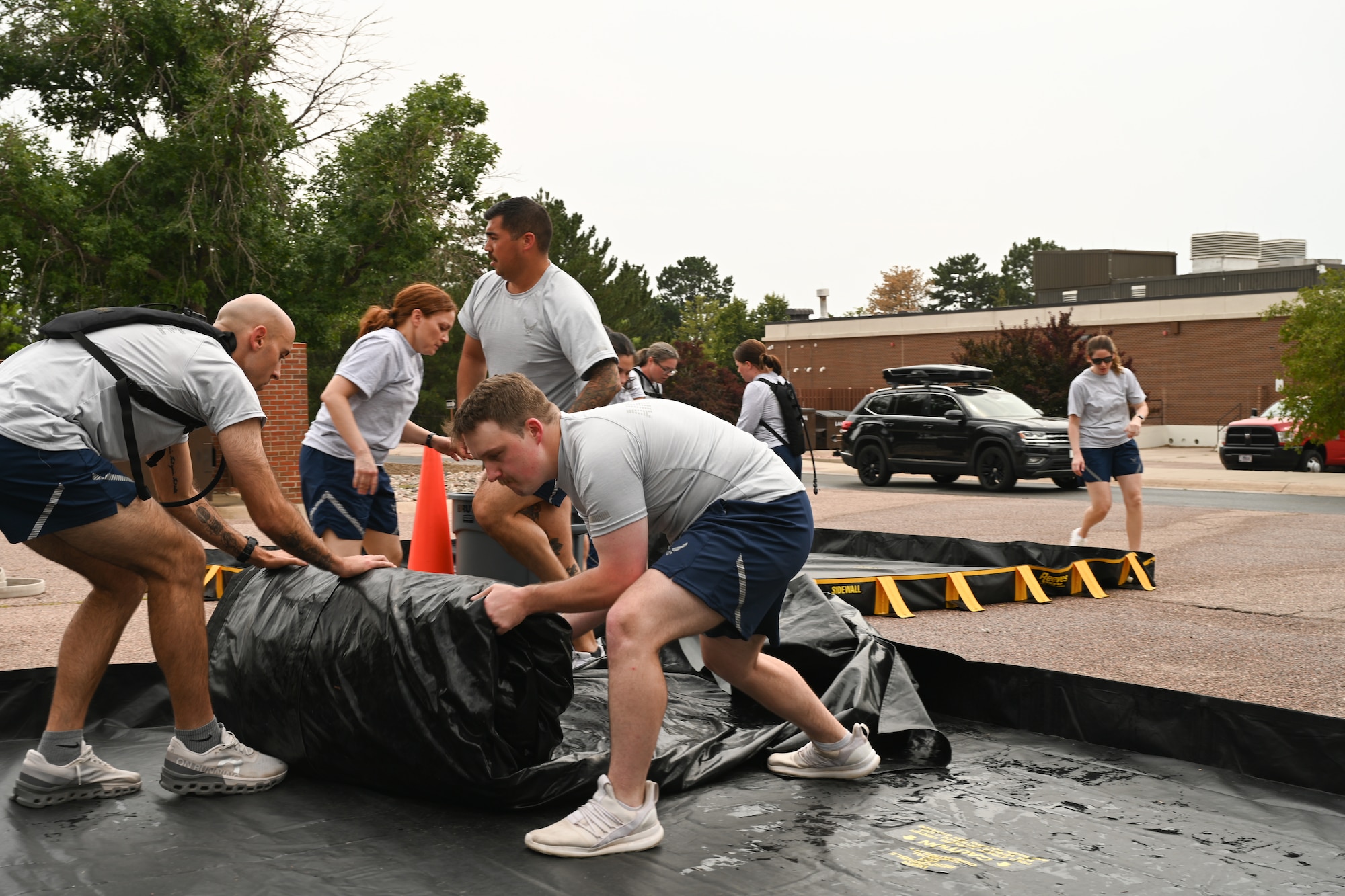 Participants work together to set up a decontamination tent.
