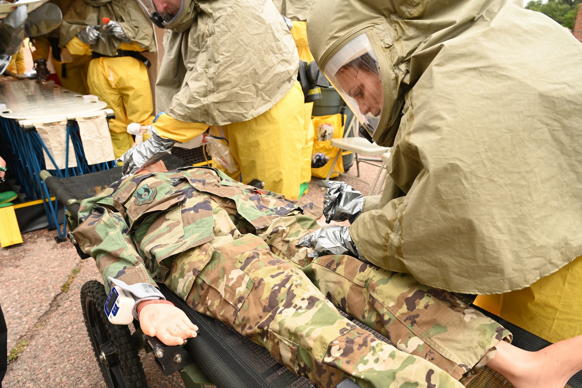 A participant is getting a patient stabilized before they get decontaminated in the tent.