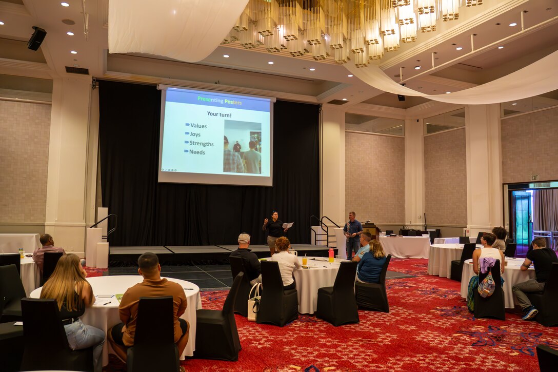 U.S. Marine Corps Staff Sgt. Jessica Suarez-Pierce, manpower chief, Marine Corps Base Camp Blaz, presents group findings from a Four Lense group activity during the Chaplain Relationship Enrichment Development Program, CREDO, marriage retreat, hosted by Marine Corps Installations Pacific, Tamuning, Guam, August 6, 2025. CREDO events provide no cost opportunities for individual, marriage, and family enrichment to boost service member morale and operational readiness. (U.S. Marine Corps Photo by Chelsey Suarez-Pierce)
