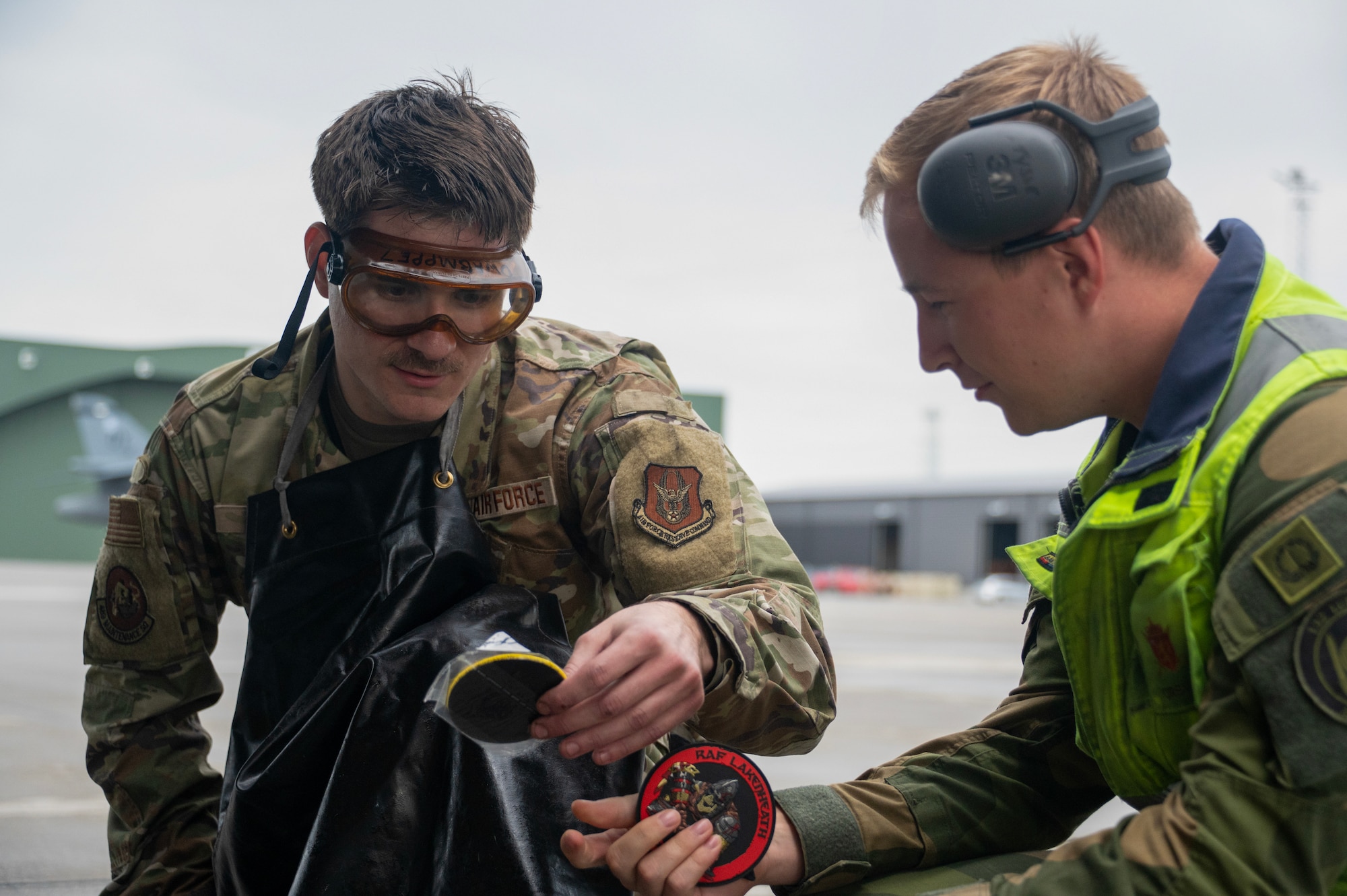 An airman walks around a plane