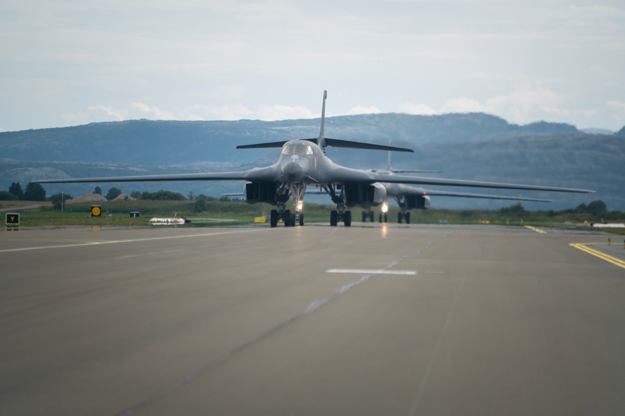 An airman walks around a plane