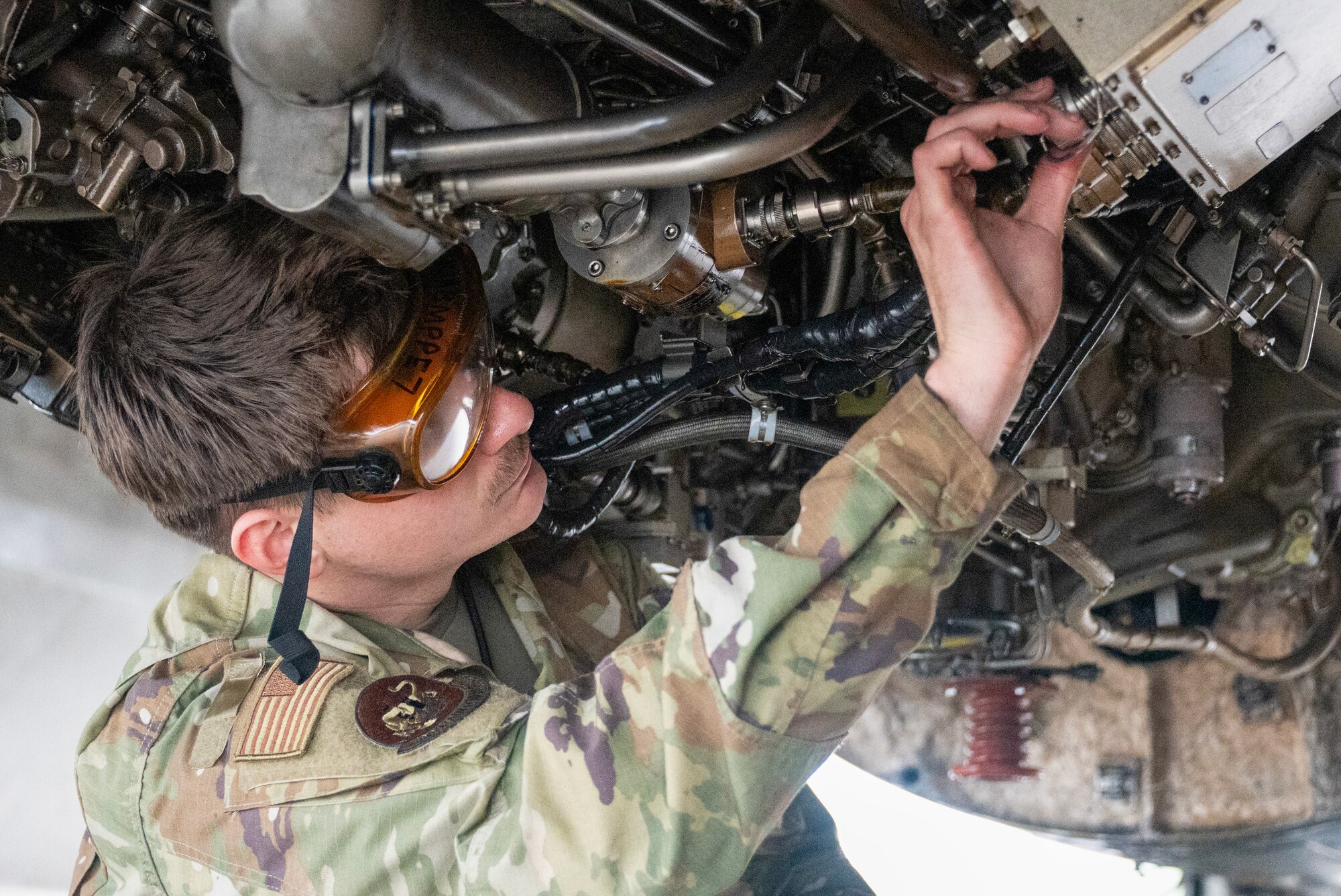 An airman walks around a plane