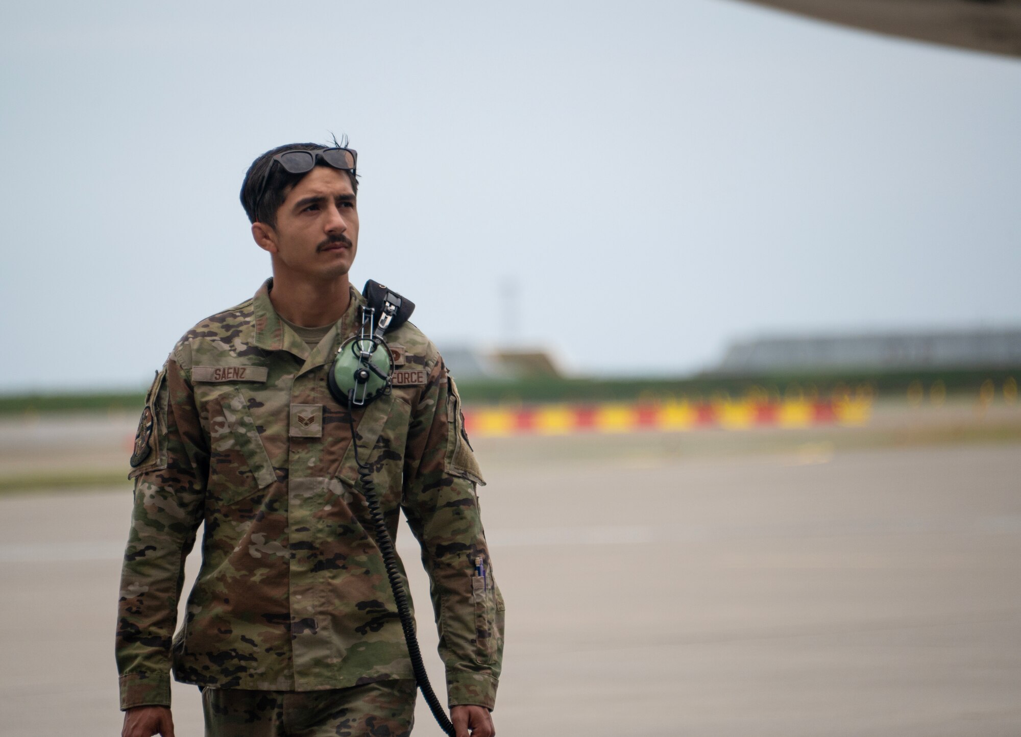 An airman walks around a plane