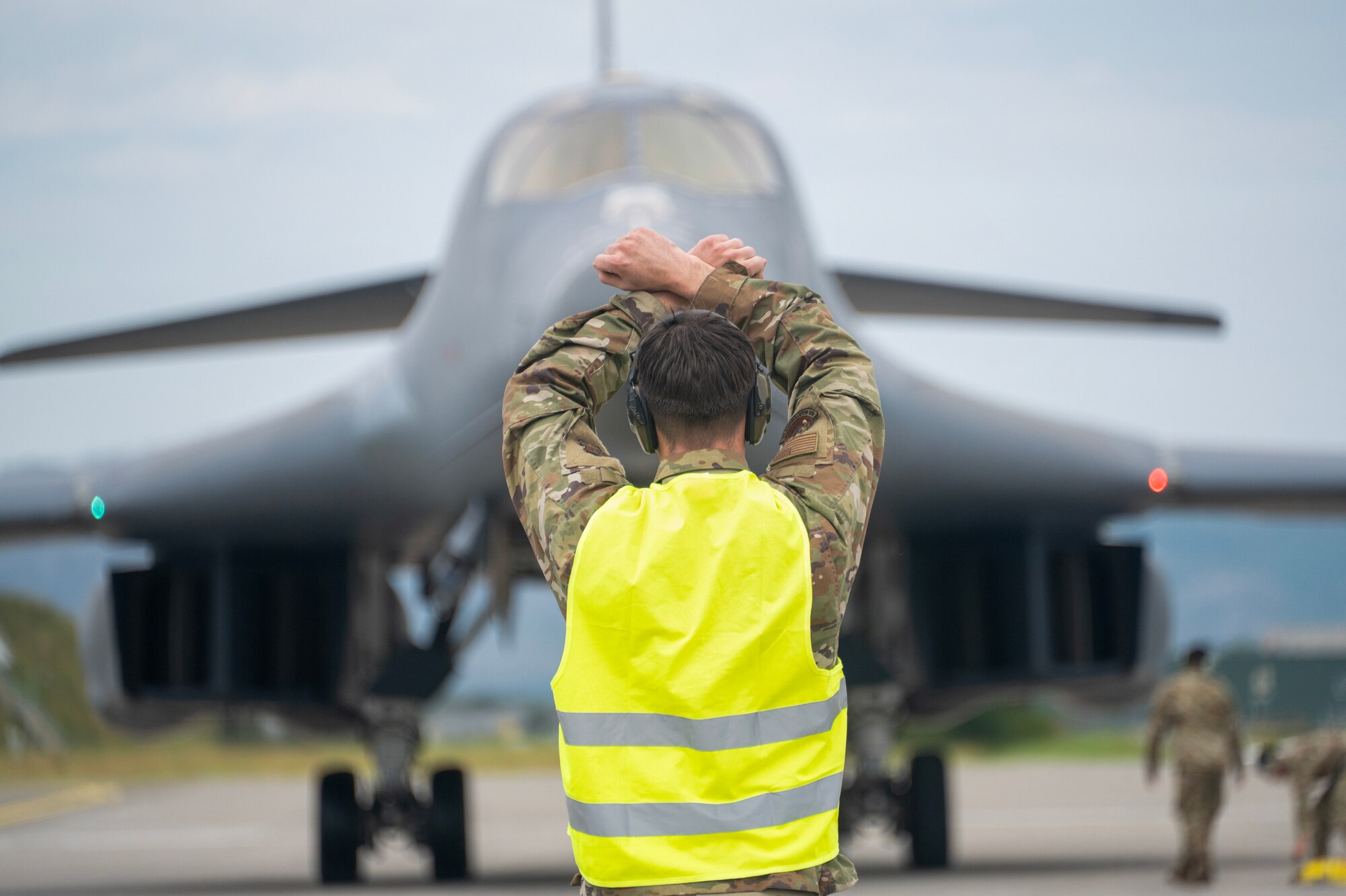 An airman walks around a plane
